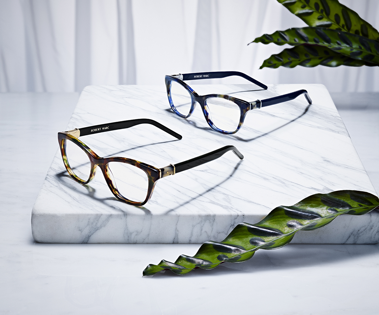 SUNGLASSES AND EYEWEAR BY ROBERT MARC SHOT ON MARBLE WITH PLANTS BY DAVID FILIBERTI