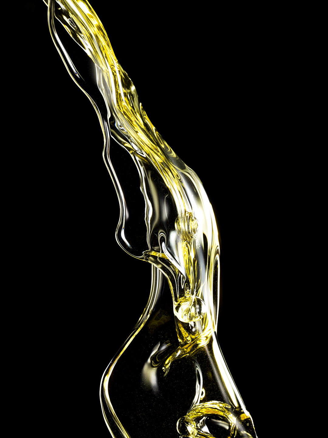 PROPRIETARY YELLOW LIQUID SHOT IN MID AIR CREATING ABSTRACT SHAPES SHOT BY DAVID FILIBERTI